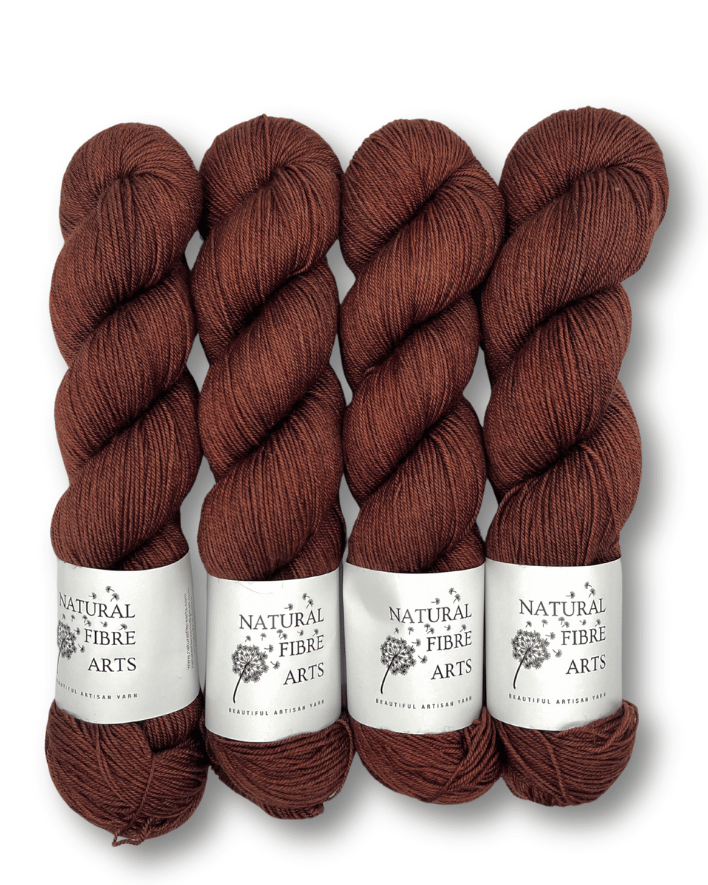 Four skeins of brown yarn with labels on a white background