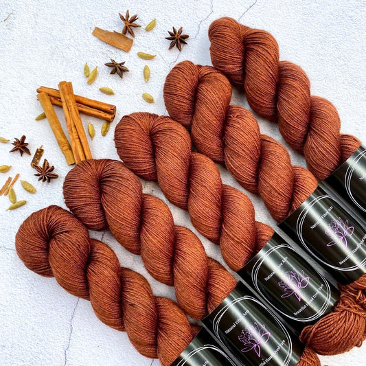 Hand dyed yarn. Rich rusty orange, semi solid, hand dyed yarn on Merino Silk Yak fingering weight 4 ply yarn.